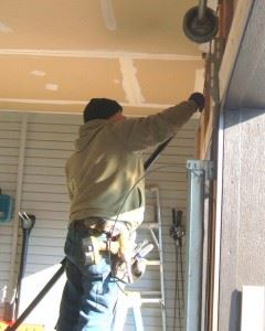 Technician Repairing Garage Door in Plano, TX